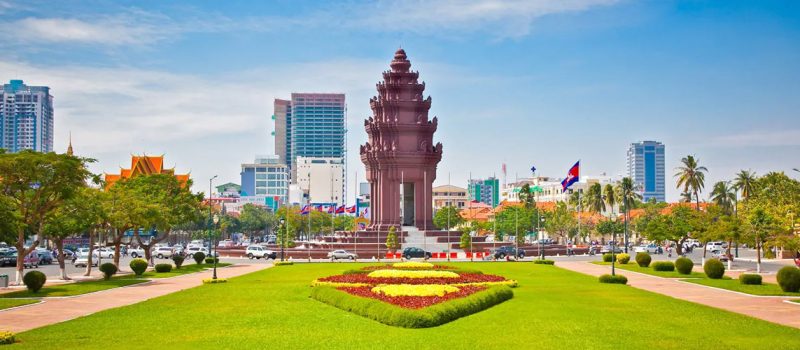The stepped tower of the Independence Monument seen along its planted median