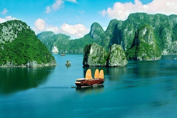 A wooden junk under sail among the limestone islands of Ha Long Bay