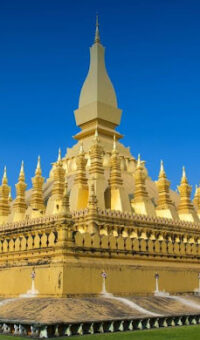The gilded stupa of Pha That Luang against a clear sky in Vientiane