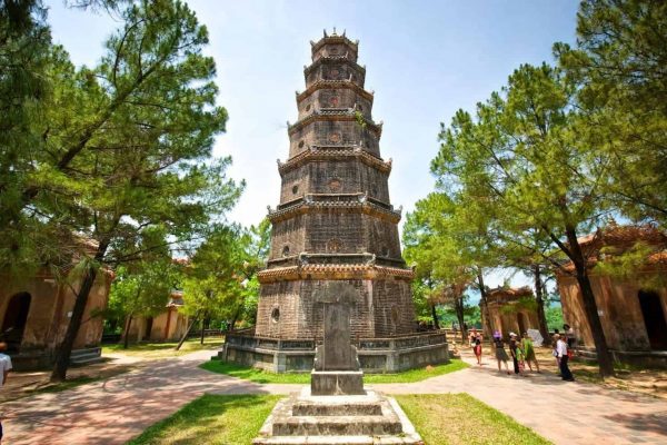 The seven tiers of Thien Mu Pagoda rising above the trees beside the Perfume River in Hue