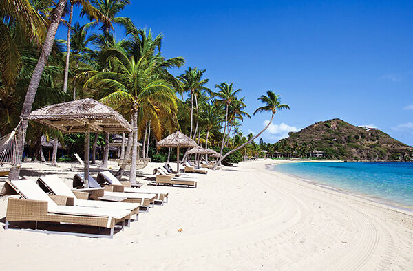 Sun loungers and palm shade on the pale sand of Sao Beach on Phu Quoc