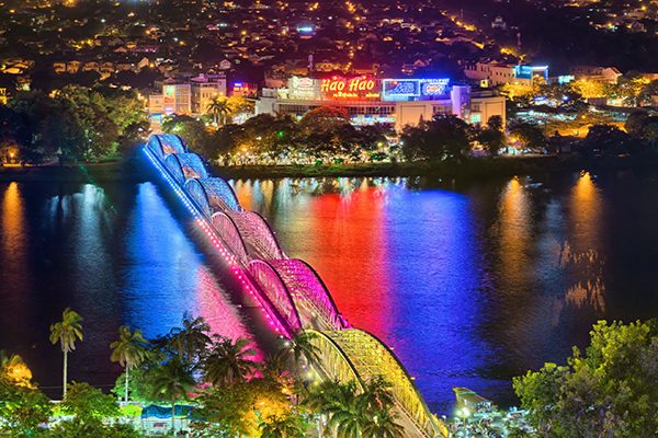 The Dragon Bridge lit in colour over the Han River in Da Nang at night